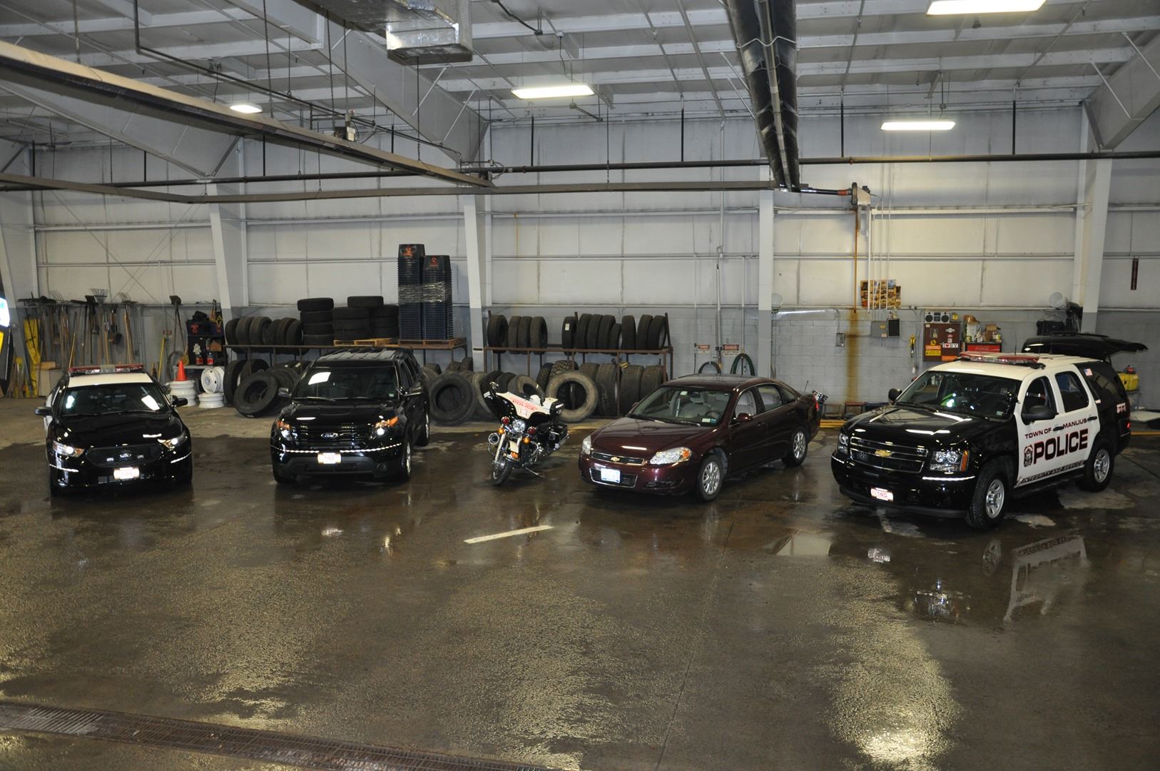 Several police vehicles in a garage